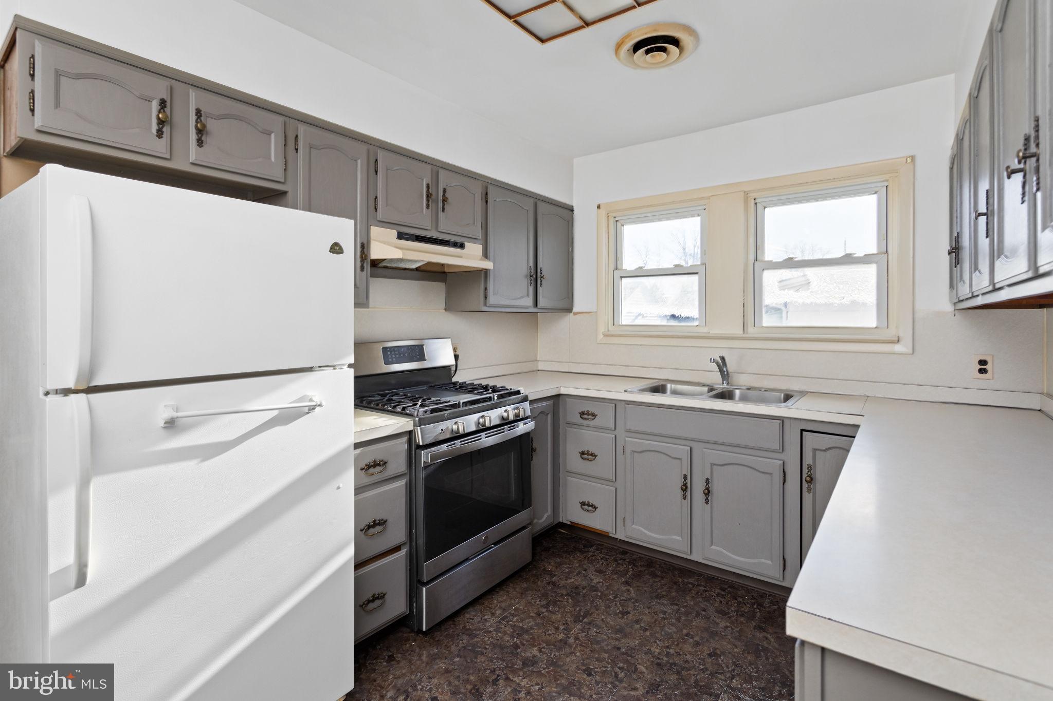 140 Maddock Avenue Hamilton, NJ 08610 - Photo 13 of 29 a kitchen with granite countertop a sink stainless steel appliances and window