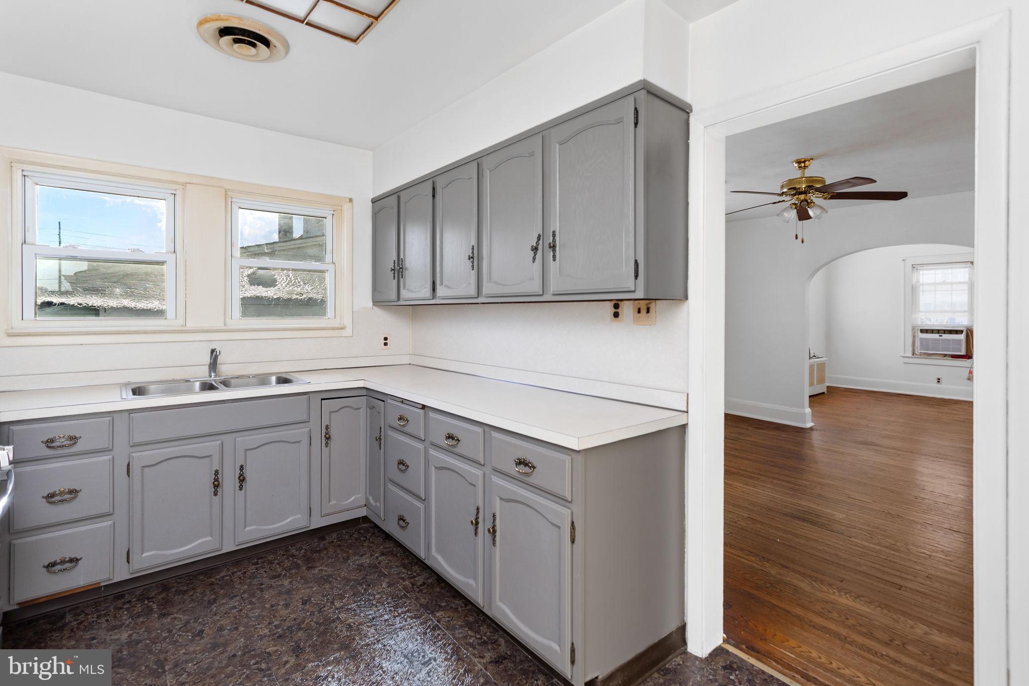 140 Maddock Avenue Hamilton, NJ 08610 - Photo 14 of 29 a kitchen with stainless steel appliances granite countertop a sink cabinets and wooden floor