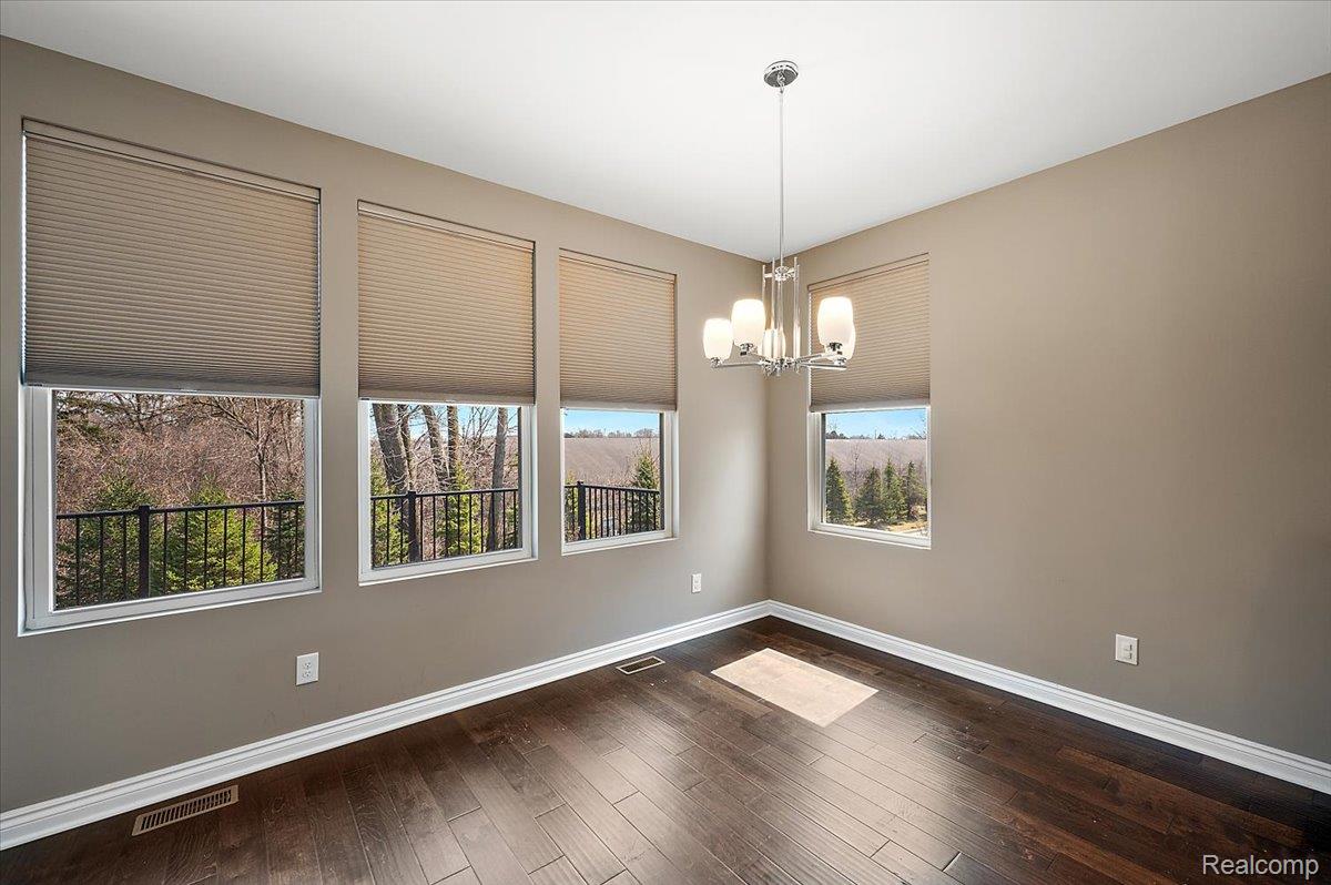 2877 Hartwick Drive Rochester, MI 48307 - Photo 21 of 44 Unfurnished room with dark wood-type flooring and suspended lighting