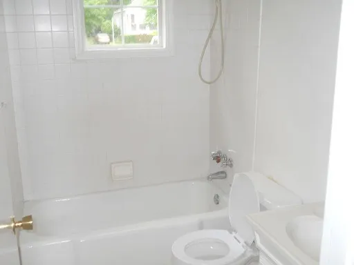 a bathroom with a bath tub with a shower