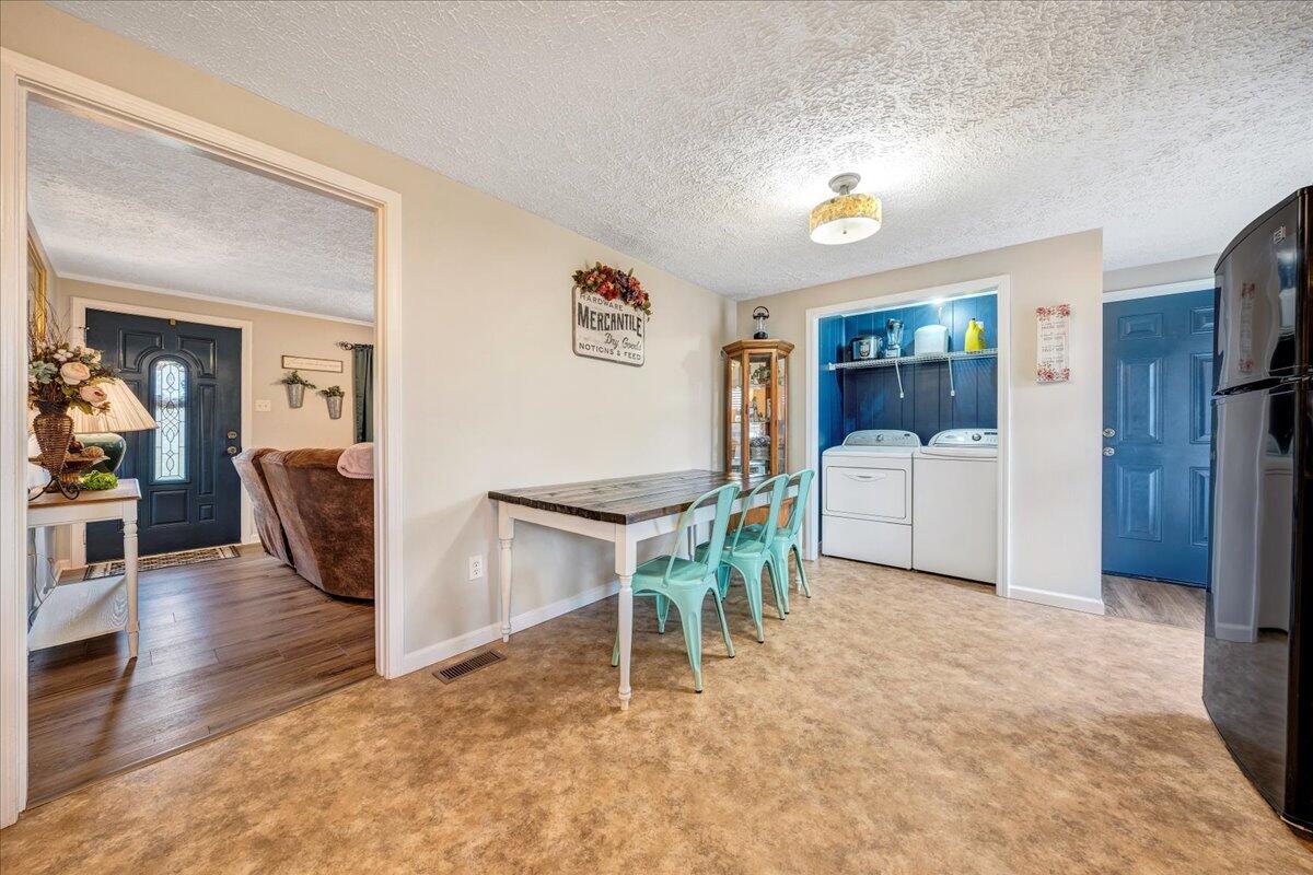 2152 Egg Farm Road Patrick Springs, VA 24133 - Photo 14 of 32 a living room with furniture a flat screen tv and a refrigerator