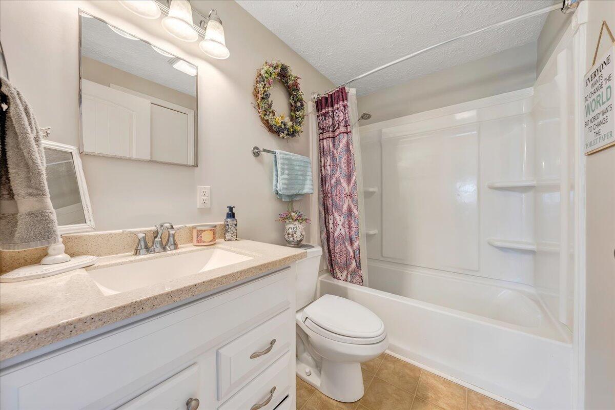 2152 Egg Farm Road Patrick Springs, VA 24133 - Photo 15 of 32 a bathroom with a granite countertop sink mirror toilet and bathtub