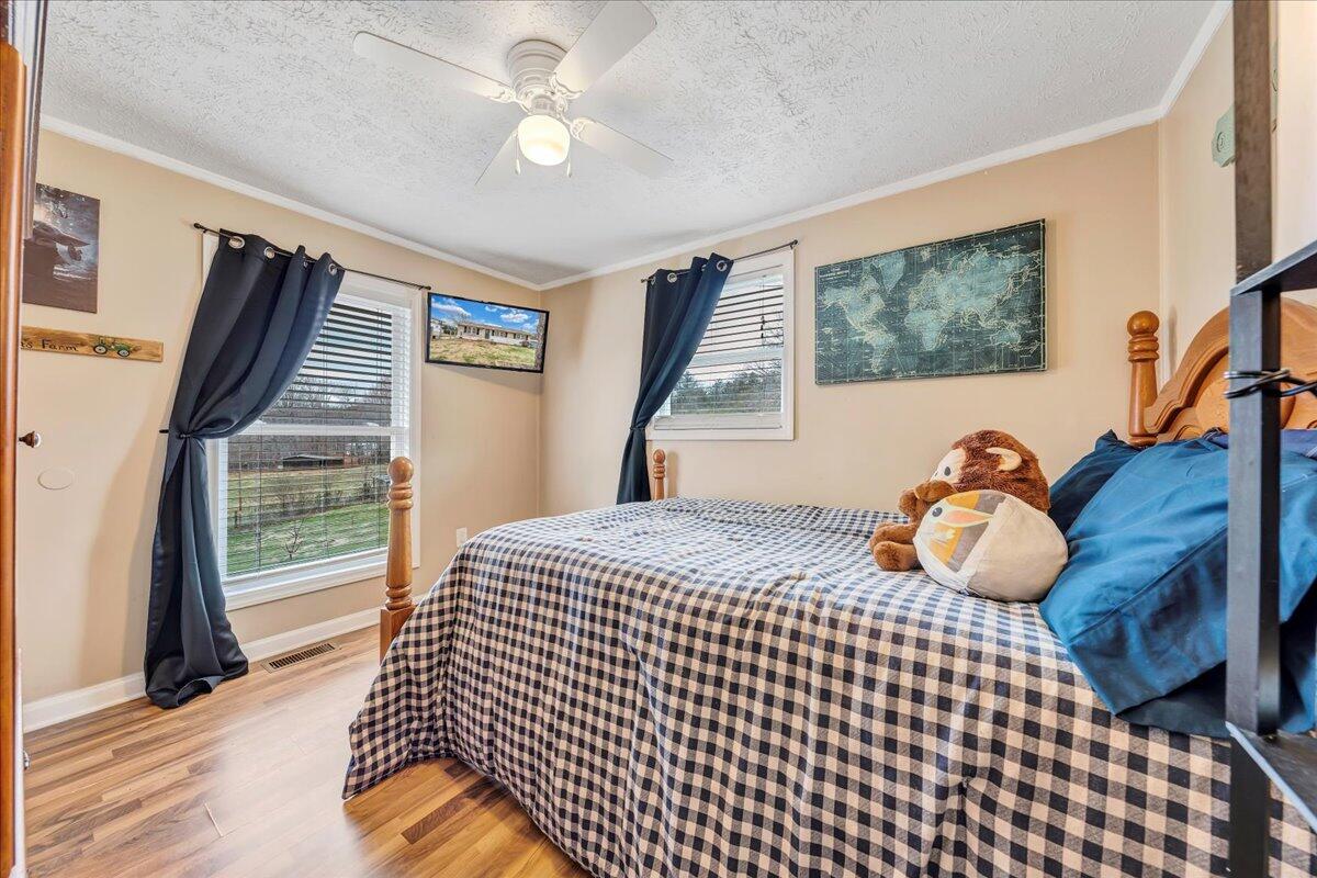 2152 Egg Farm Road Patrick Springs, VA 24133 - Photo 18 of 32 a bedroom with a bed and wooden floor