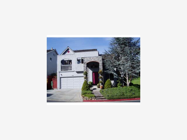 a picture of a living room with a table and chairs
