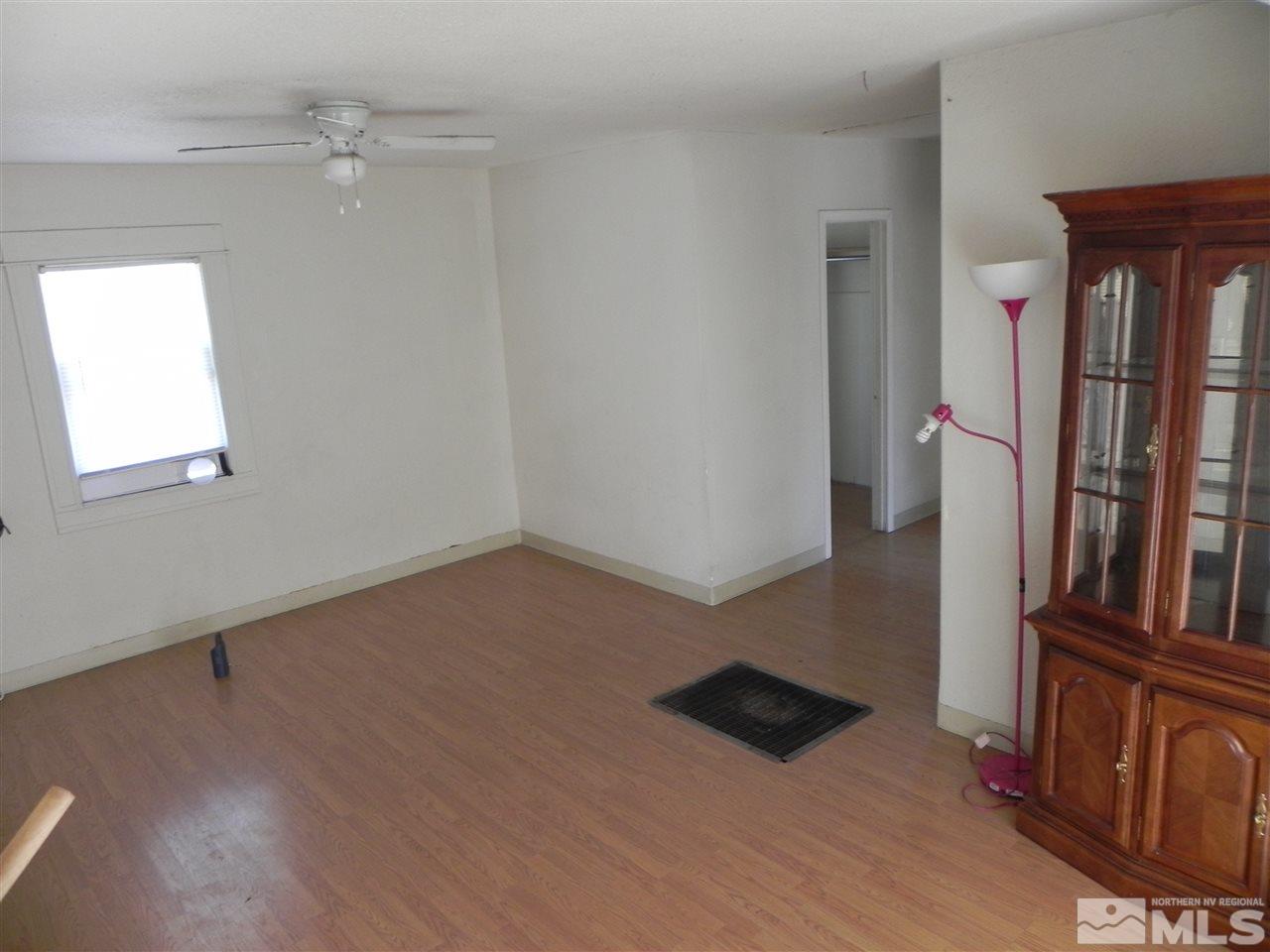 624 Quincy Street Reno, NV 89512 - Photo 4 of 17 an empty room with wooden floor and windows