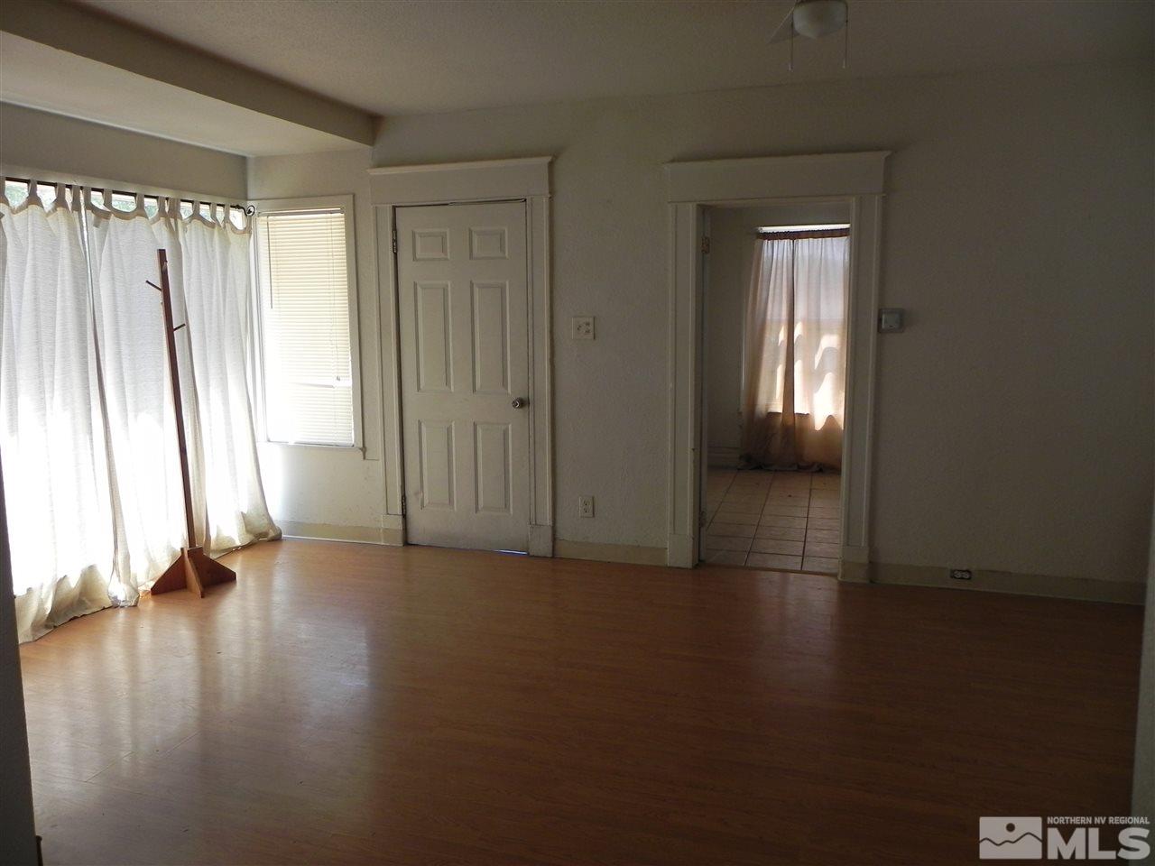 624 Quincy Street Reno, NV 89512 - Photo 6 of 17 an empty room with wooden floor and windows