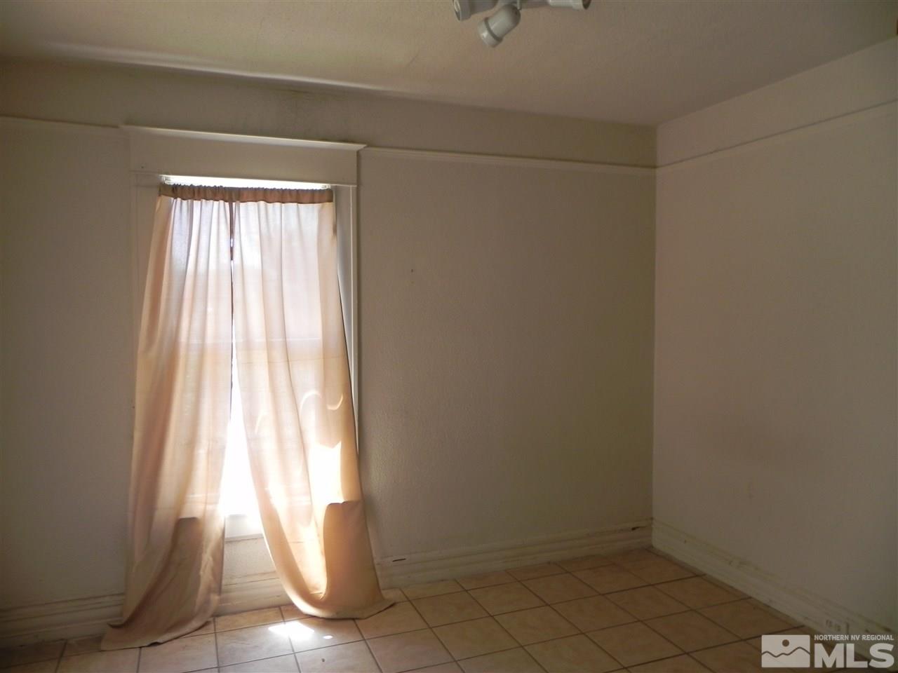 624 Quincy Street Reno, NV 89512 - Photo 7 of 17 a view of empty room with wooden floor and fan