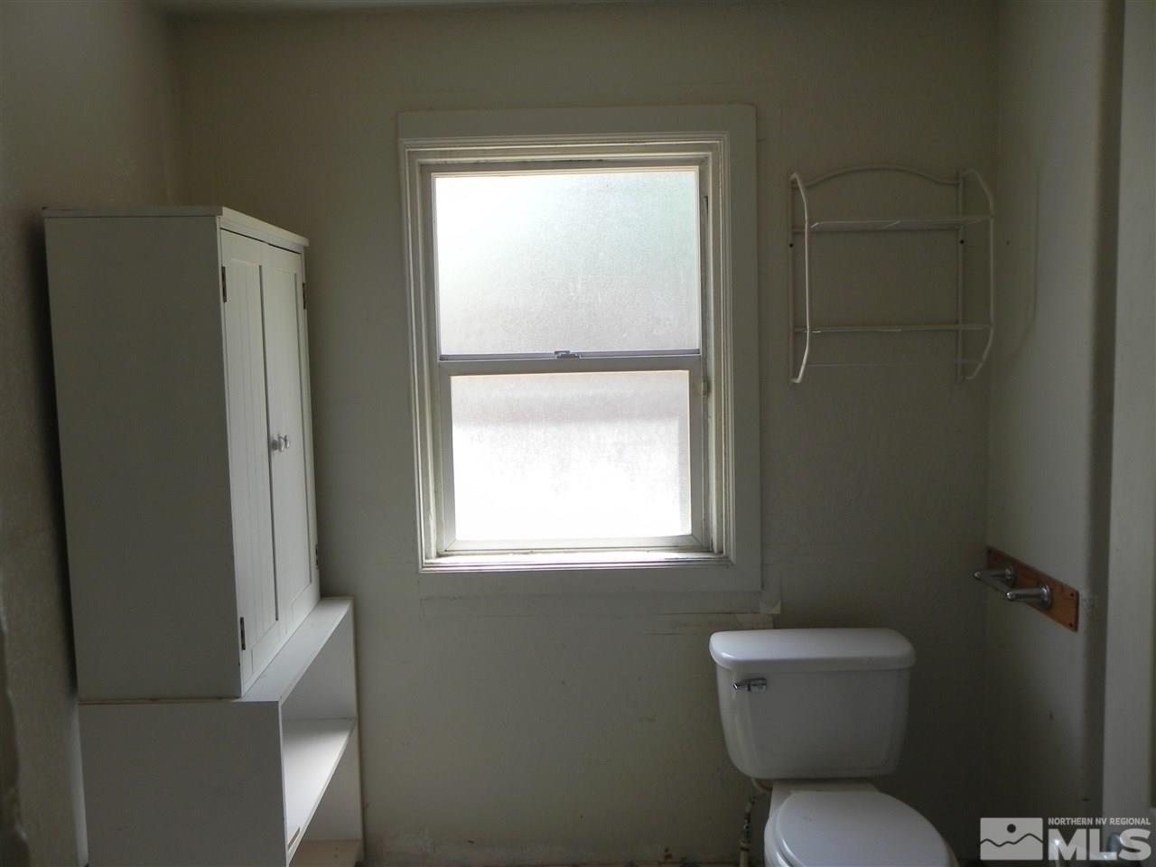 624 Quincy Street Reno, NV 89512 - Photo 9 of 17 a white toilet sitting next to a window in a bathroom