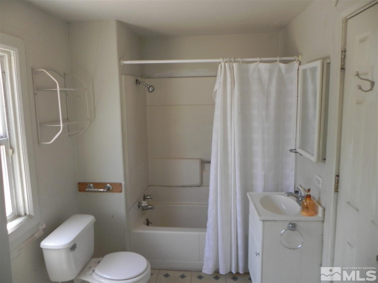 624 Quincy Street Reno, NV 89512 - Photo 10 of 17 a bathroom with a shower curtain and a toilet