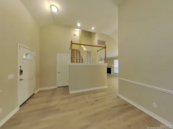 an empty room with closet and windows