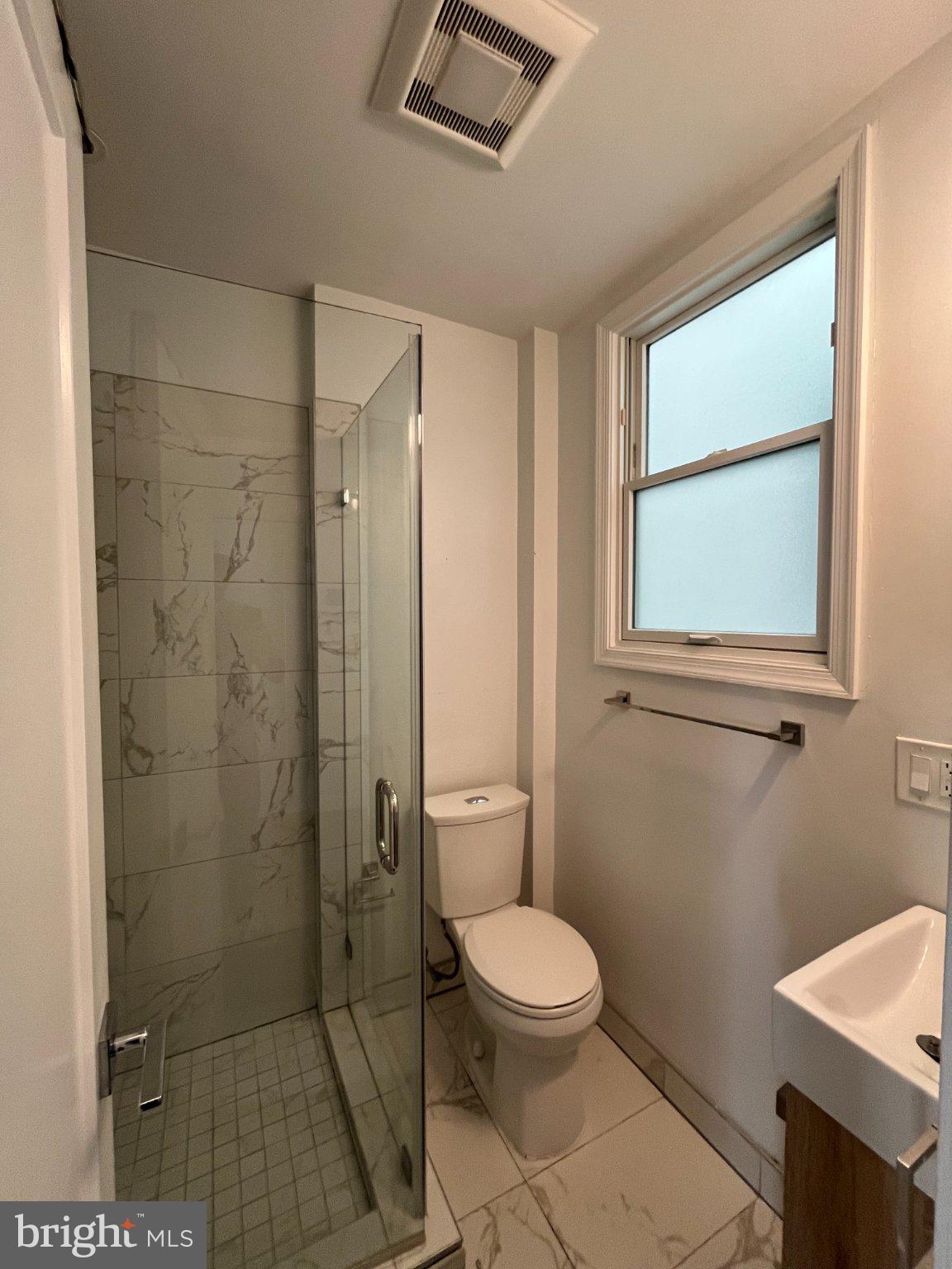3003 P Street Northwest Washington, DC 20007 - Photo 3 of 7 a bathroom with a toilet a sink and shower