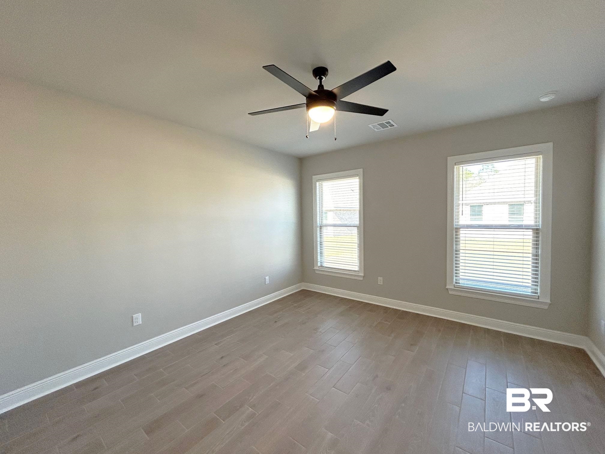 877 Sumter Loop Foley, AL 36535 - Photo 7 of 18 Spare room with visible vents, baseboards, and wood finished floors