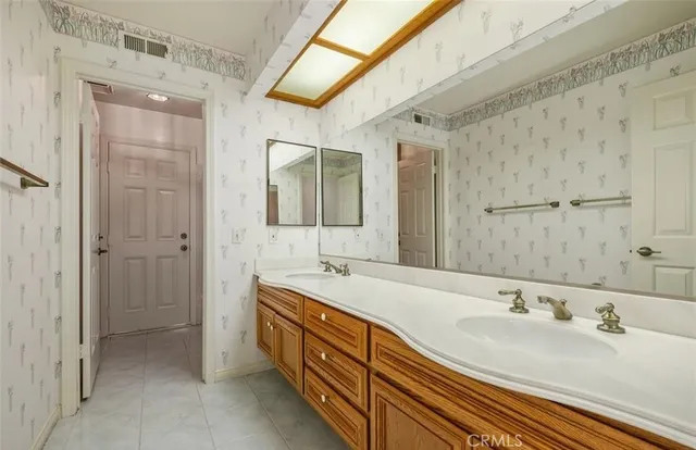 a spacious bathroom with a double vanity sink mirror and double