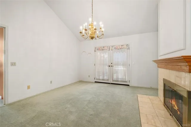 a view of a kitchen and an empty room