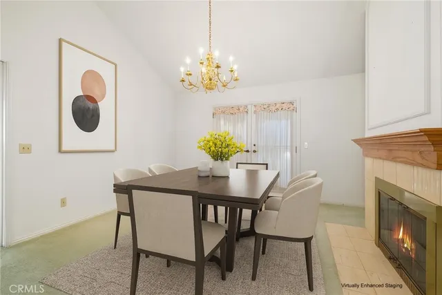 a view of a dining room with furniture and chandelier