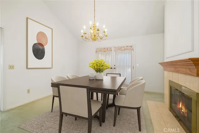 a view of a dining room with furniture and chandelier