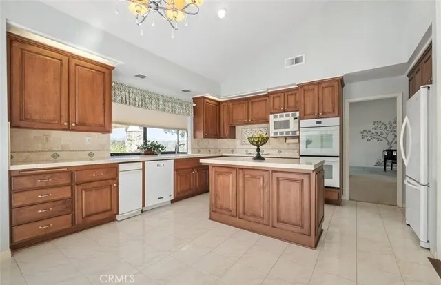 a kitchen with stainless steel appliances granite countertop a refrigerator sink and cabinets
