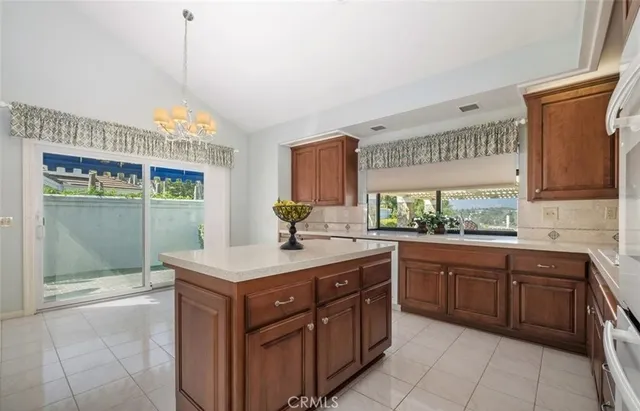 a kitchen with a sink stove and wooden cabinets