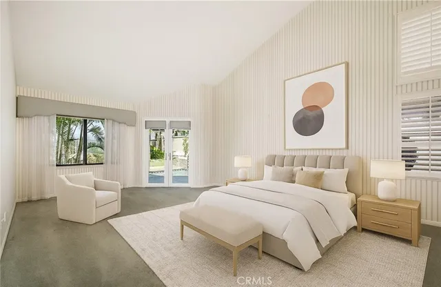 a bedroom with a bed and a large window