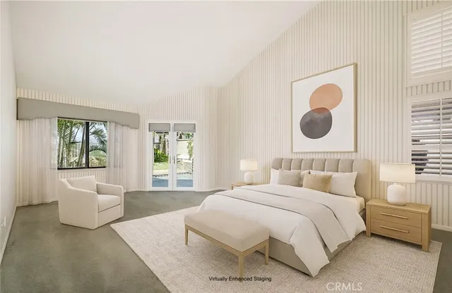 a bedroom with a bed and a large window