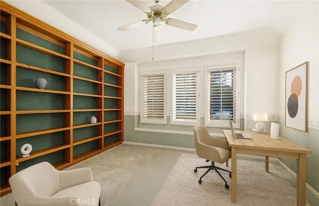 a view of a livingroom with workspace and a couch