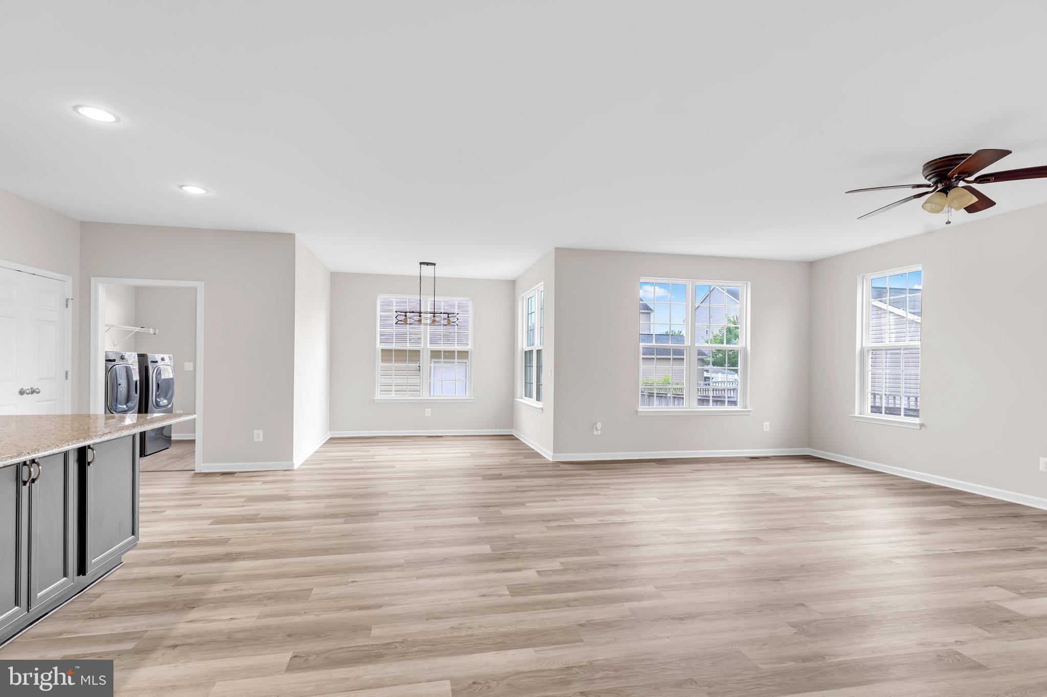 12021 Spring Beauty Road Bristow, VA 20136 - Photo 13 of 43 wooden floor in an empty room with a window