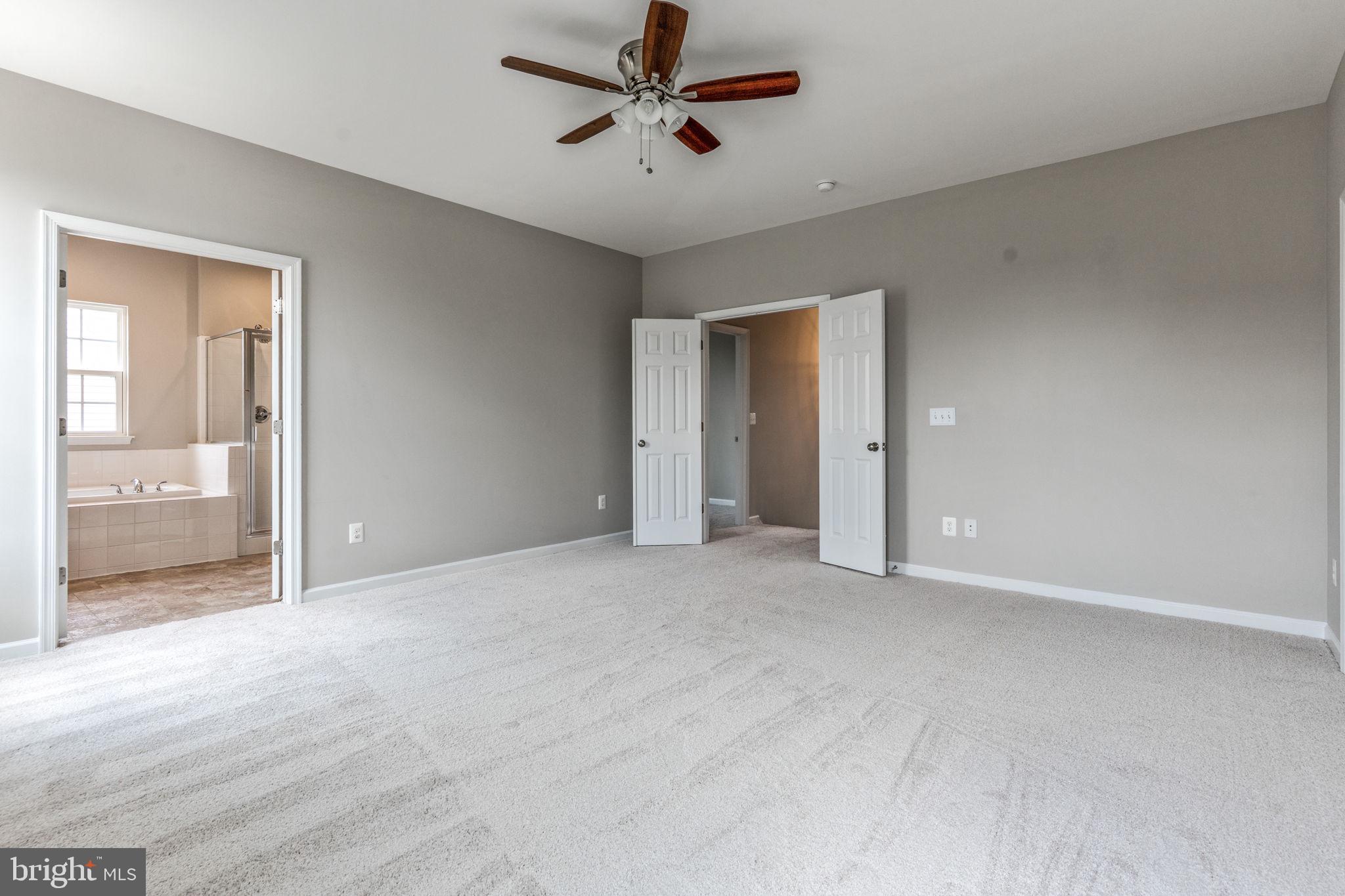 12021 Spring Beauty Road Bristow, VA 20136 - Photo 19 of 43 an empty room with fan and windows