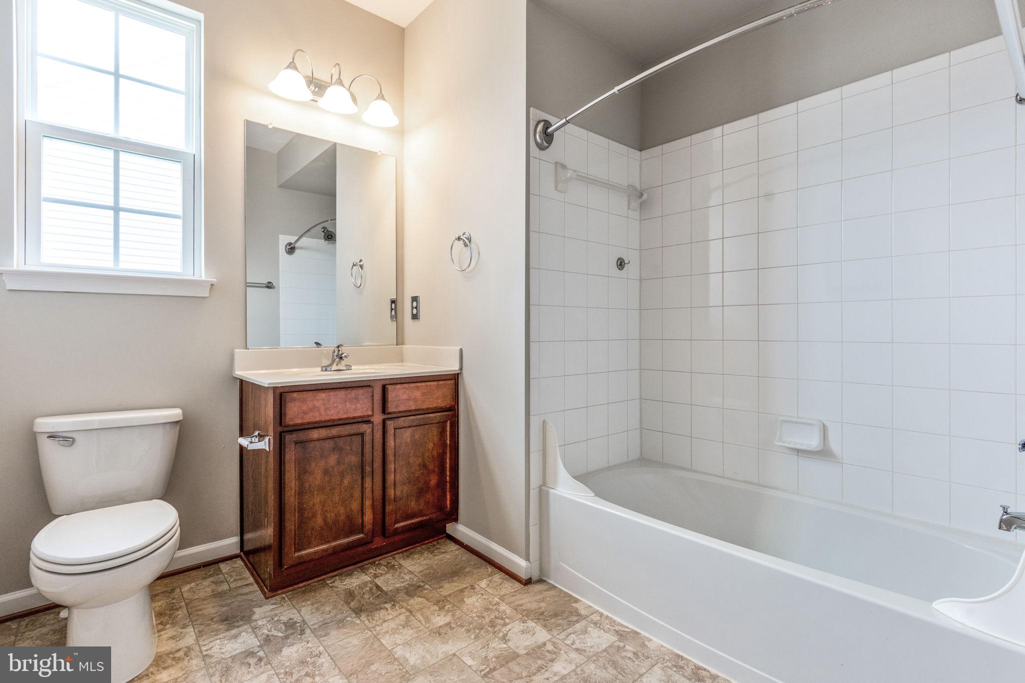 12021 Spring Beauty Road Bristow, VA 20136 - Photo 21 of 43 a bathroom with a sink a toilet and bathtub