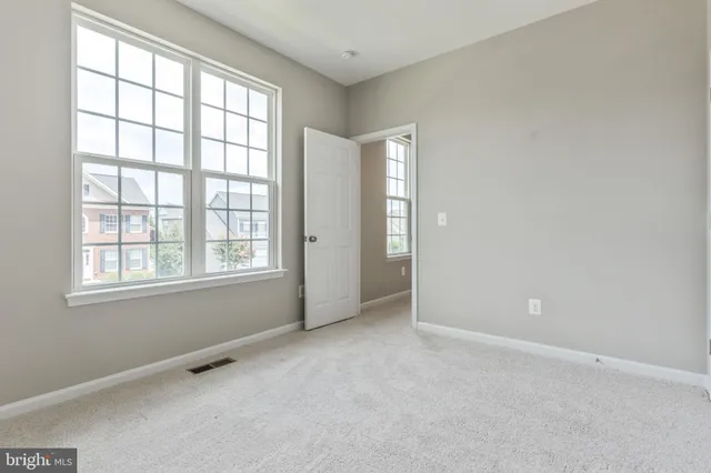 an empty room with windows and closet