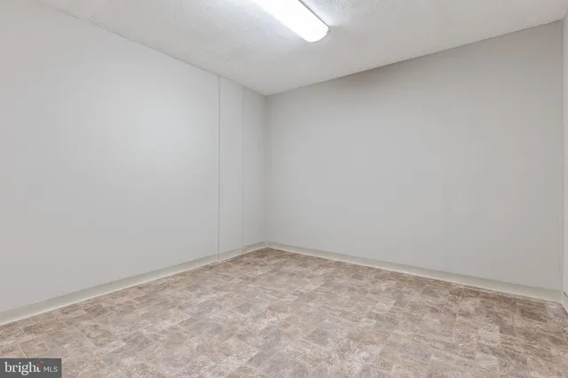 an empty room with a bench