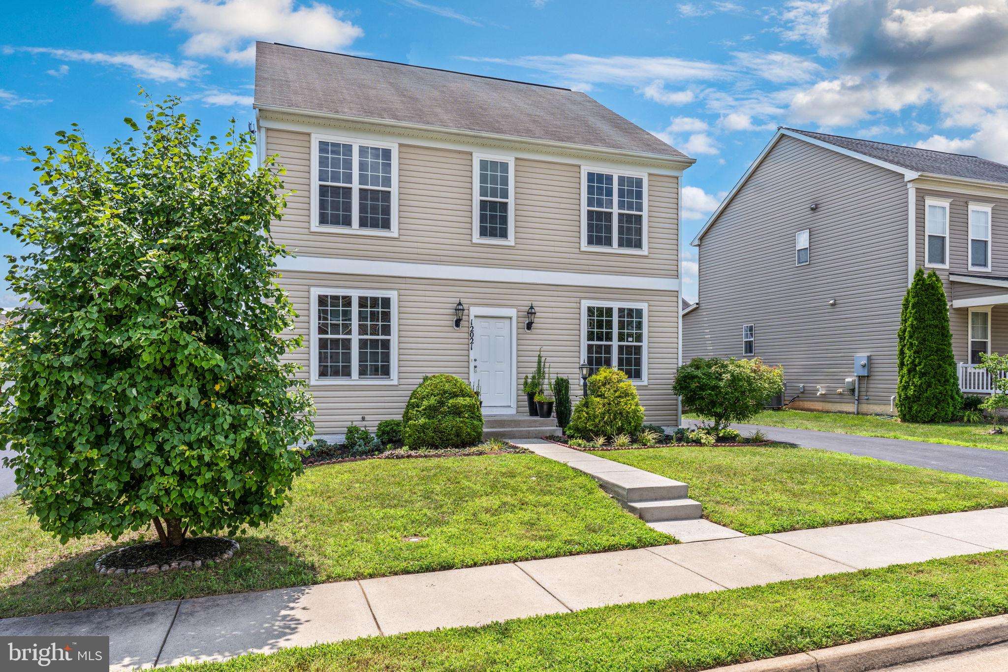 12021 Spring Beauty Road Bristow, VA 20136 - Photo 3 of 43 a front view of a house with a yard