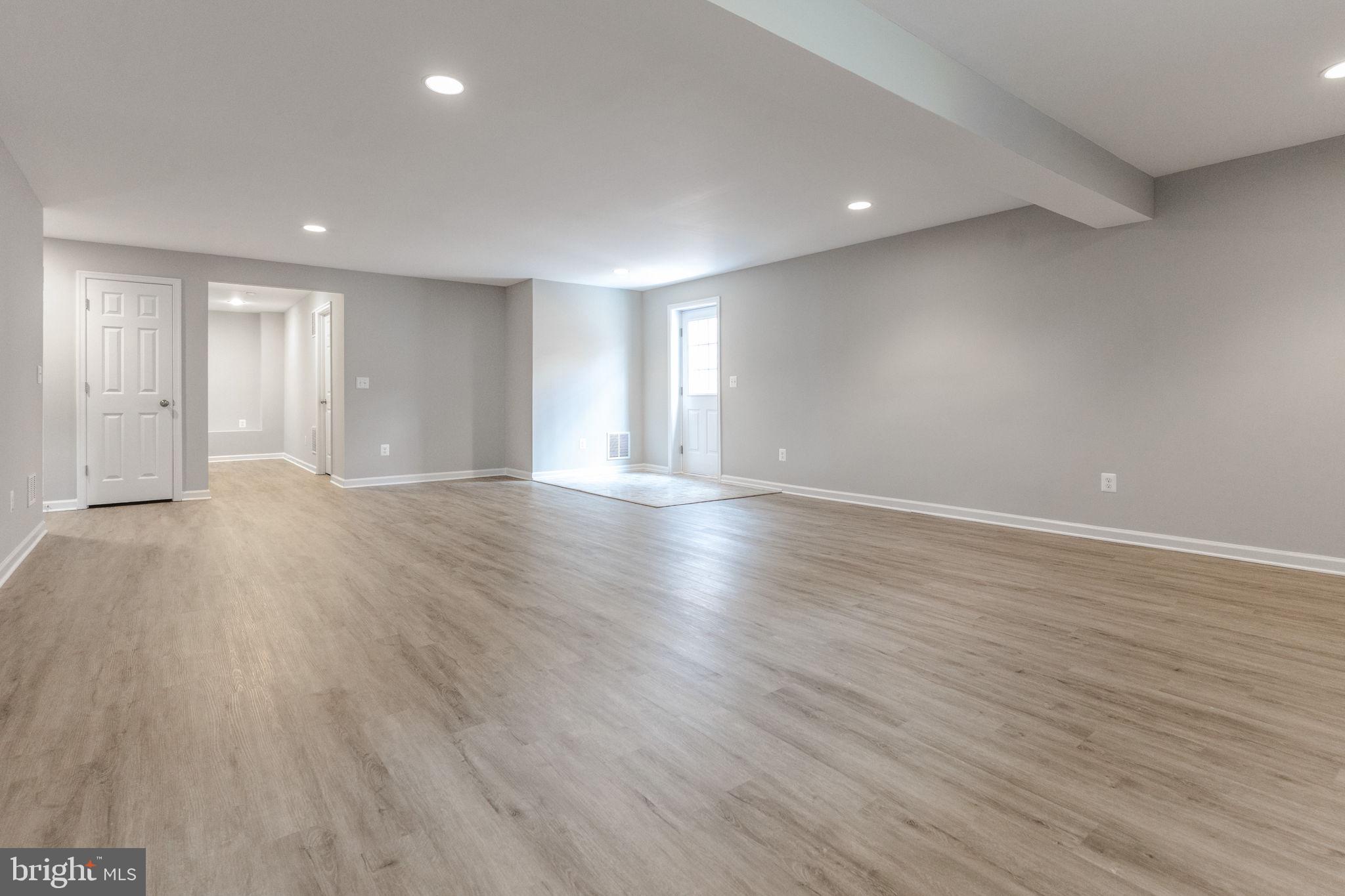 12021 Spring Beauty Road Bristow, VA 20136 - Photo 34 of 43 a view of an empty room with wooden floor and a window