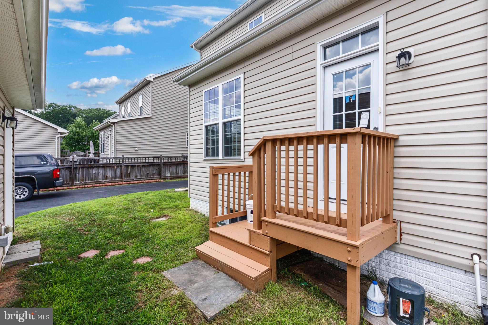 12021 Spring Beauty Road Bristow, VA 20136 - Photo 38 of 43 a view of a house with backyard and sitting area