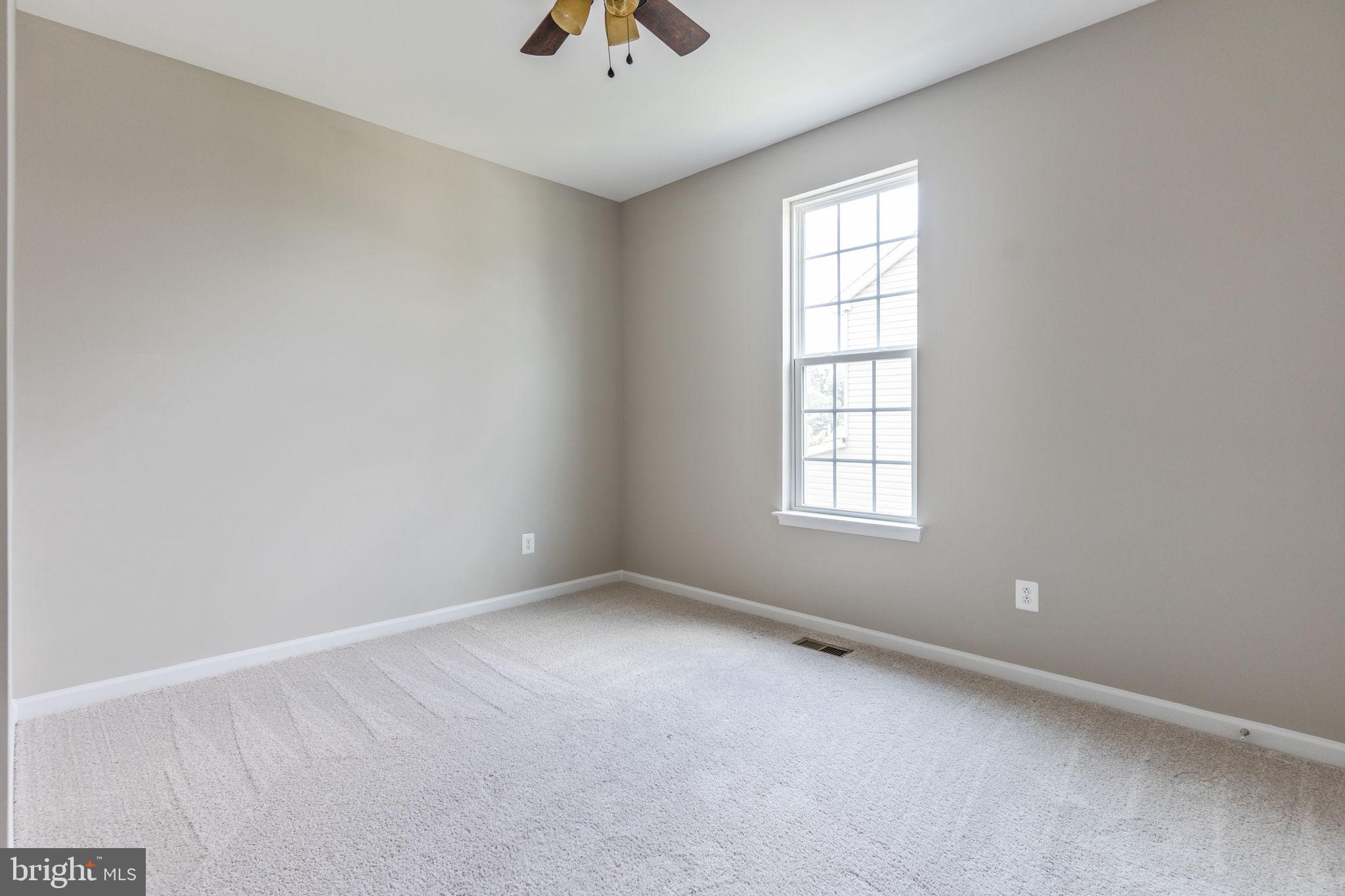 12021 Spring Beauty Road Bristow, VA 20136 - Photo 7 of 43 an empty room with a window