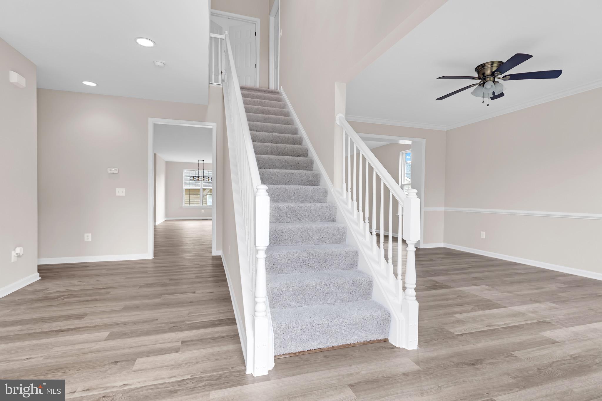 12021 Spring Beauty Road Bristow, VA 20136 - Photo 8 of 43 a view of a hallway view with wooden floor and staircase