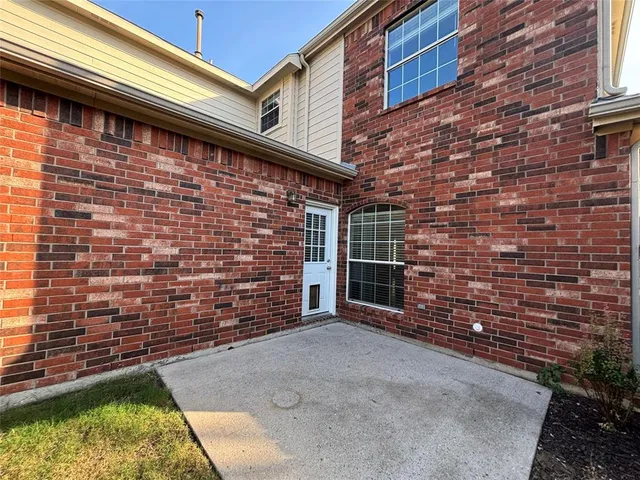 a view of front door of house with an window
