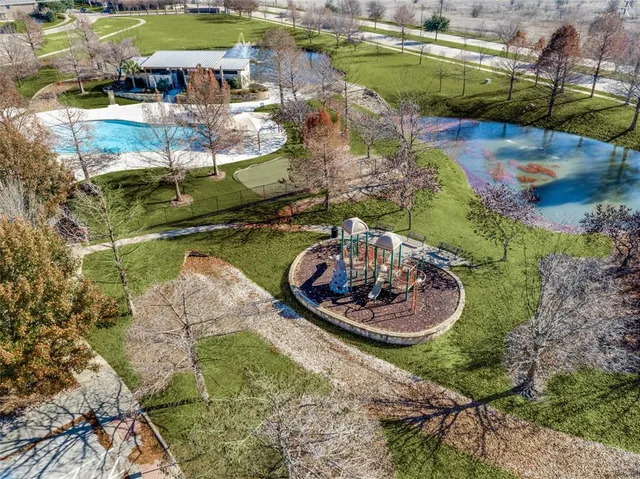 a view of a swimming pool with a yard