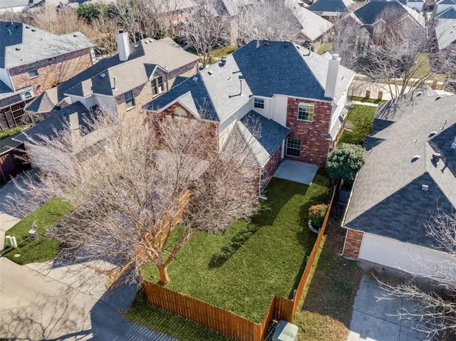 an aerial view of a house with a yard basket ball court and outdoor seating