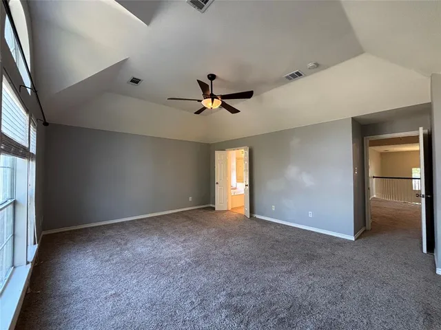 an empty room with closet and windows