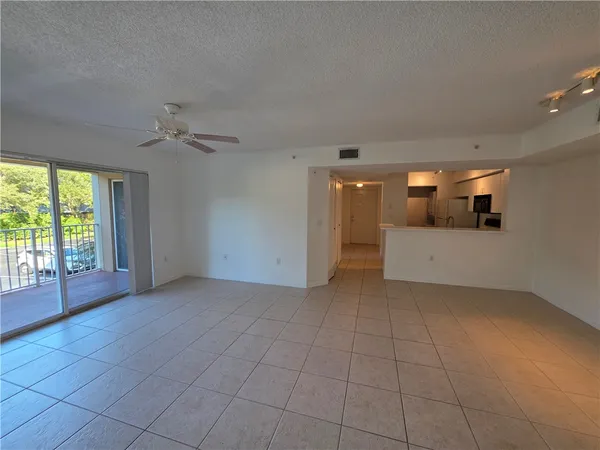 a view of a livingroom with an empty space and a window