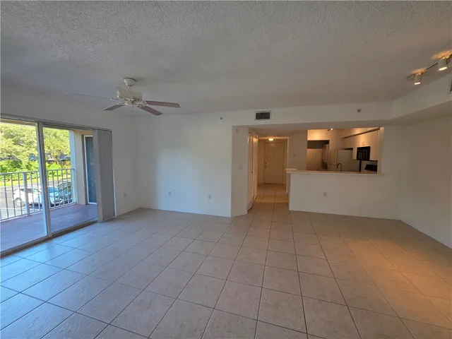 a view of a livingroom with an empty space and a window