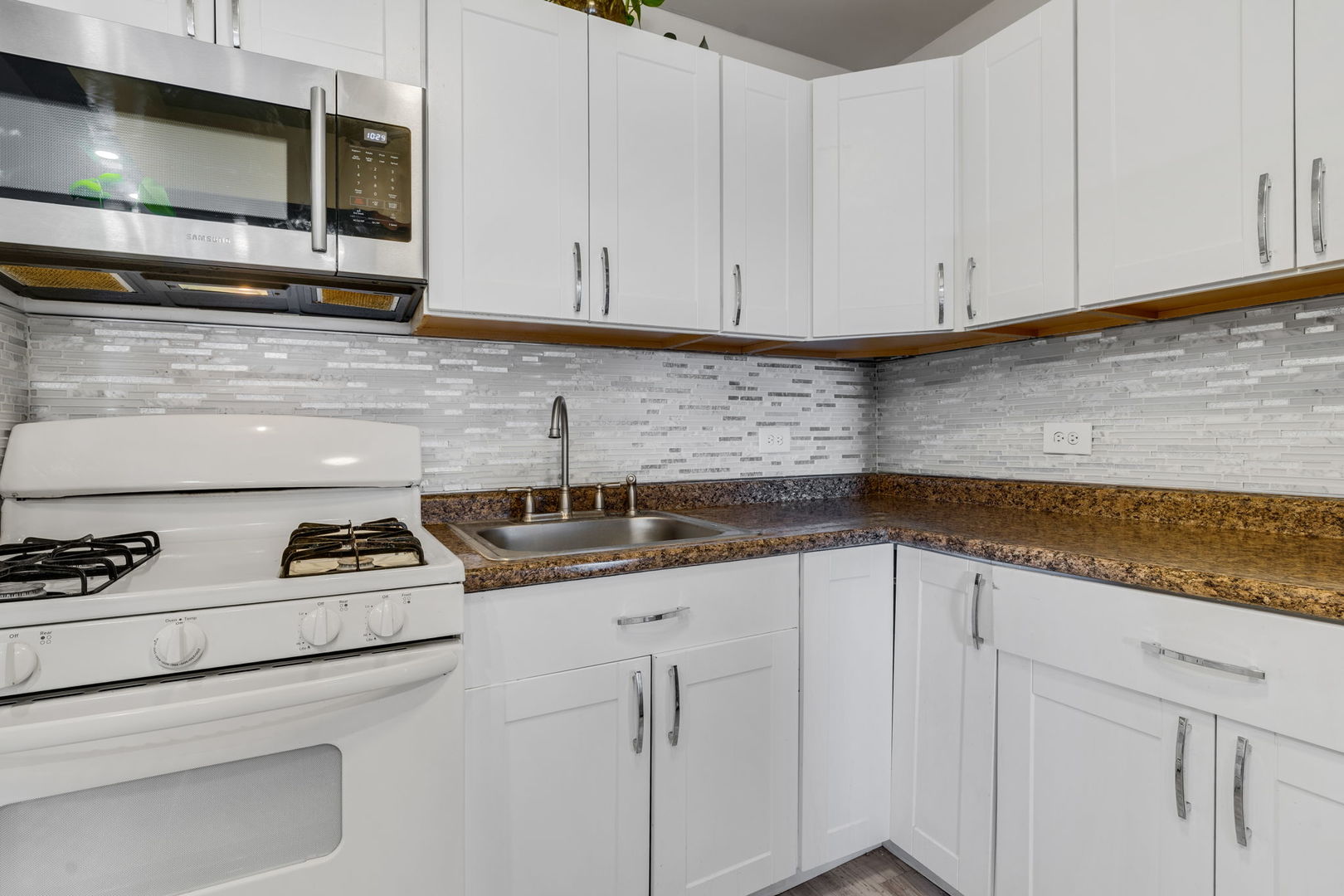 9820 South Pulaski Road, Unit 315 Oak Lawn, IL 60453 - Photo 3 of 20 a kitchen with white cabinets and appliances