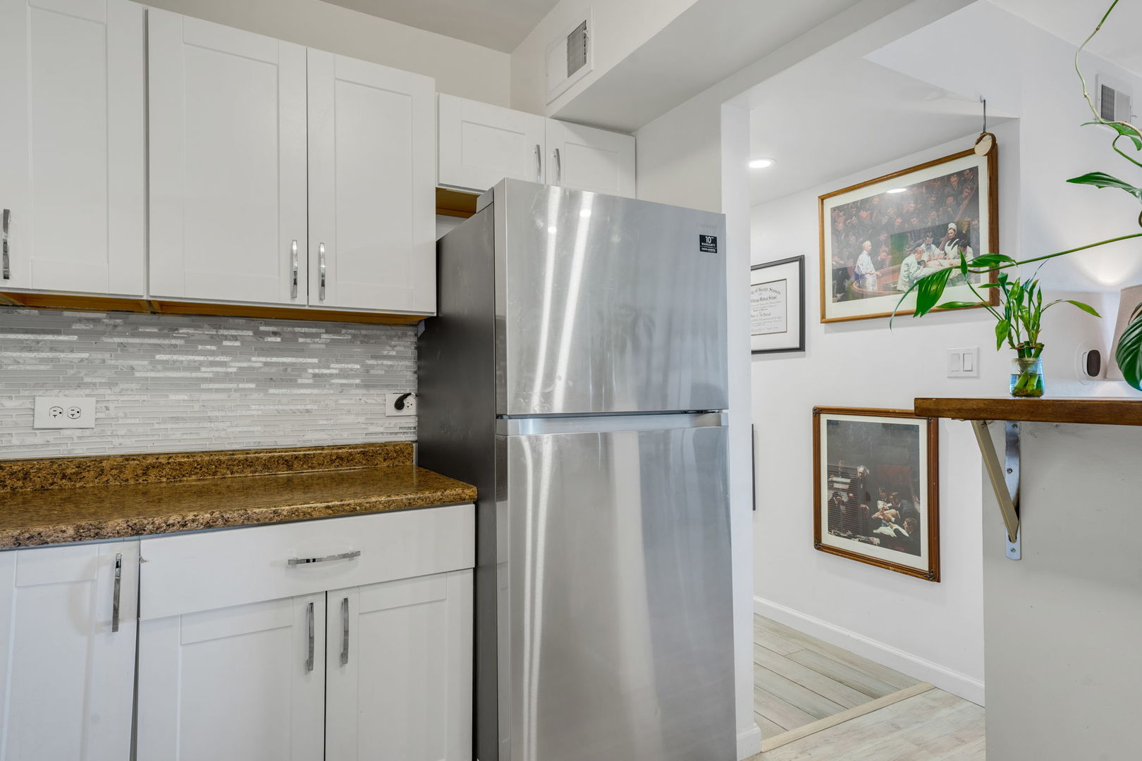 9820 South Pulaski Road, Unit 315 Oak Lawn, IL 60453 - Photo 5 of 20 a kitchen with stainless steel appliances granite countertop a refrigerator a microwave a sink and white cabinets