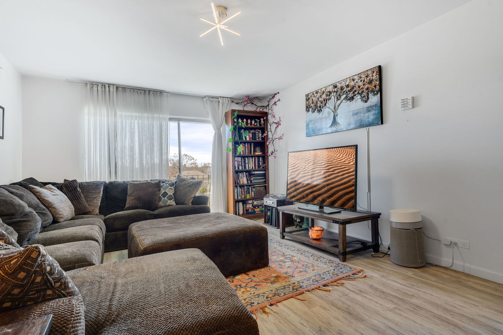 9820 South Pulaski Road, Unit 315 Oak Lawn, IL 60453 - Photo 9 of 20 a living room with furniture and a flat screen tv