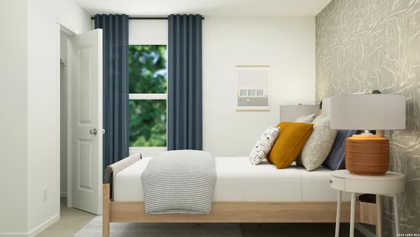 a bedroom with a bed and window