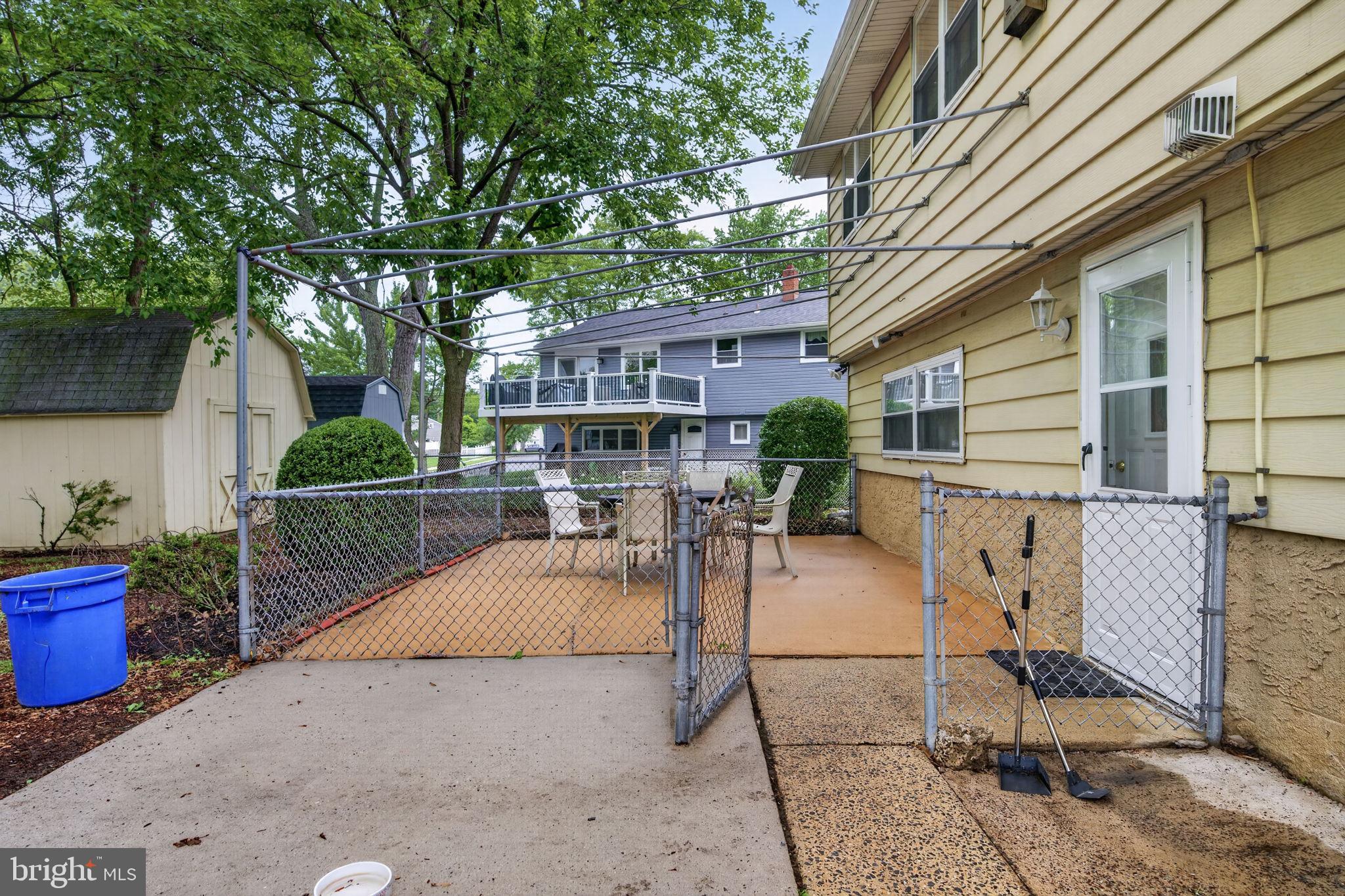46 Trinity Avenue Marlton, NJ 08053 - Photo 35 of 37 a view of a patio with table and chairs potted plants and a barbeque