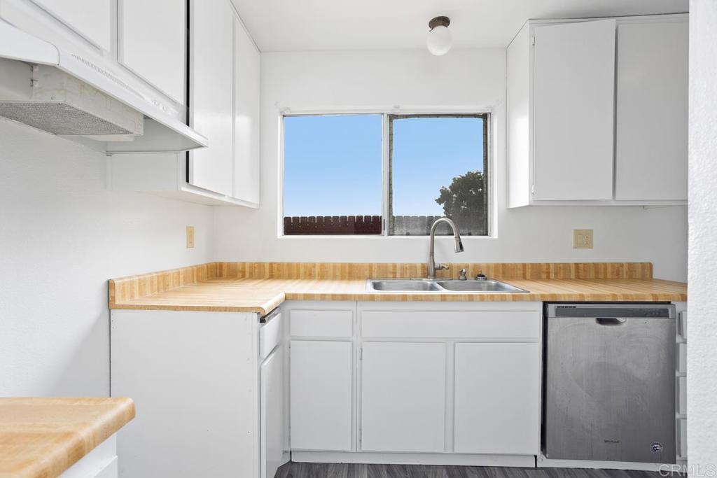 4537 Beverly Glen Drive Oceanside, CA 92056 - Photo 18 of 30 a kitchen with cabinets appliances and a counter top