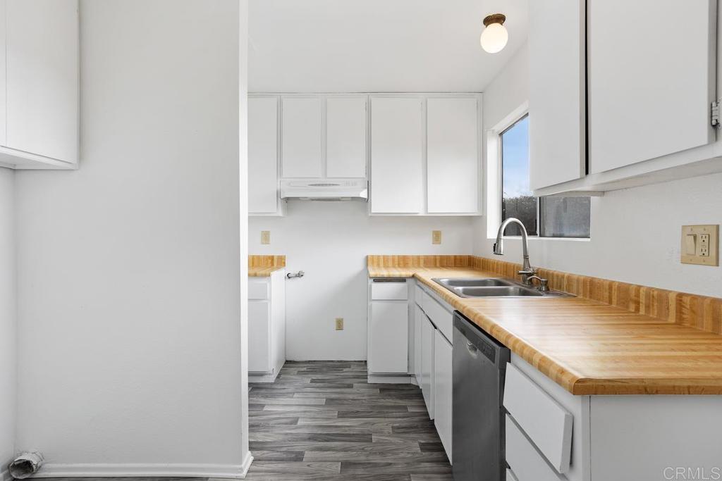 4537 Beverly Glen Drive Oceanside, CA 92056 - Photo 19 of 30 a kitchen with a sink stove and cabinets