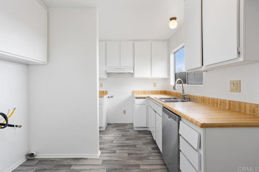 4537 Beverly Glen Drive Oceanside, CA 92056 - Photo 22 of 30 a kitchen with a sink stove and cabinets