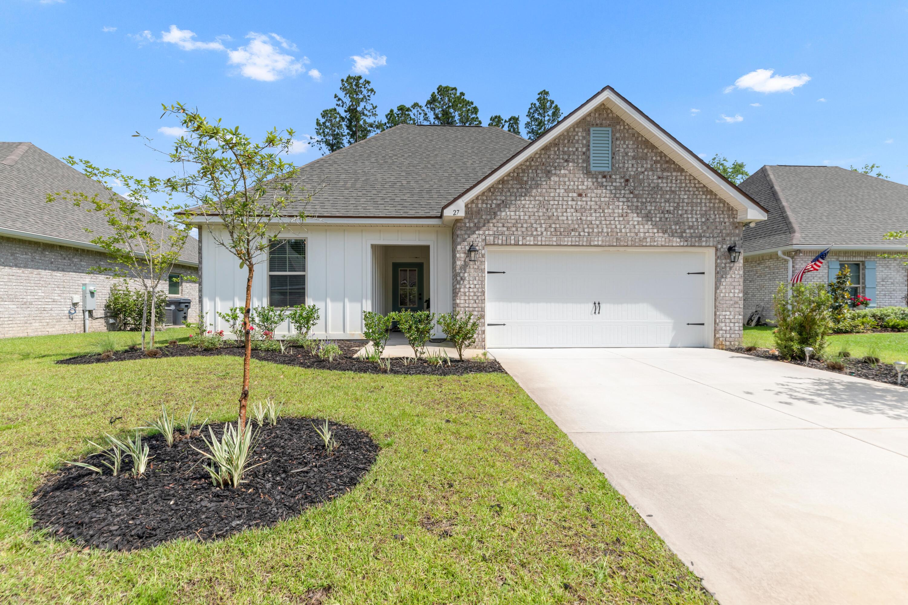 27 Cozy Cove Freeport, FL 32439 - Photo 1 of 80 a front view of a house with garden